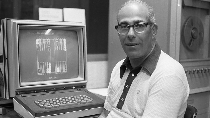 Hans Berliner sitting next to a computer terminal 