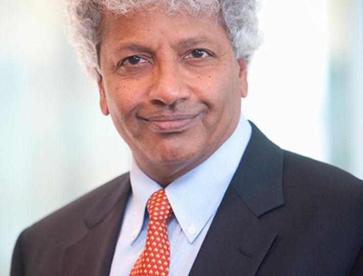 Portrait photo of Mahadev Satyanarayanan in a dark blue suit and bright red pattered tie.