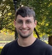 Portrait photo of Aviv Bick with trees in the background